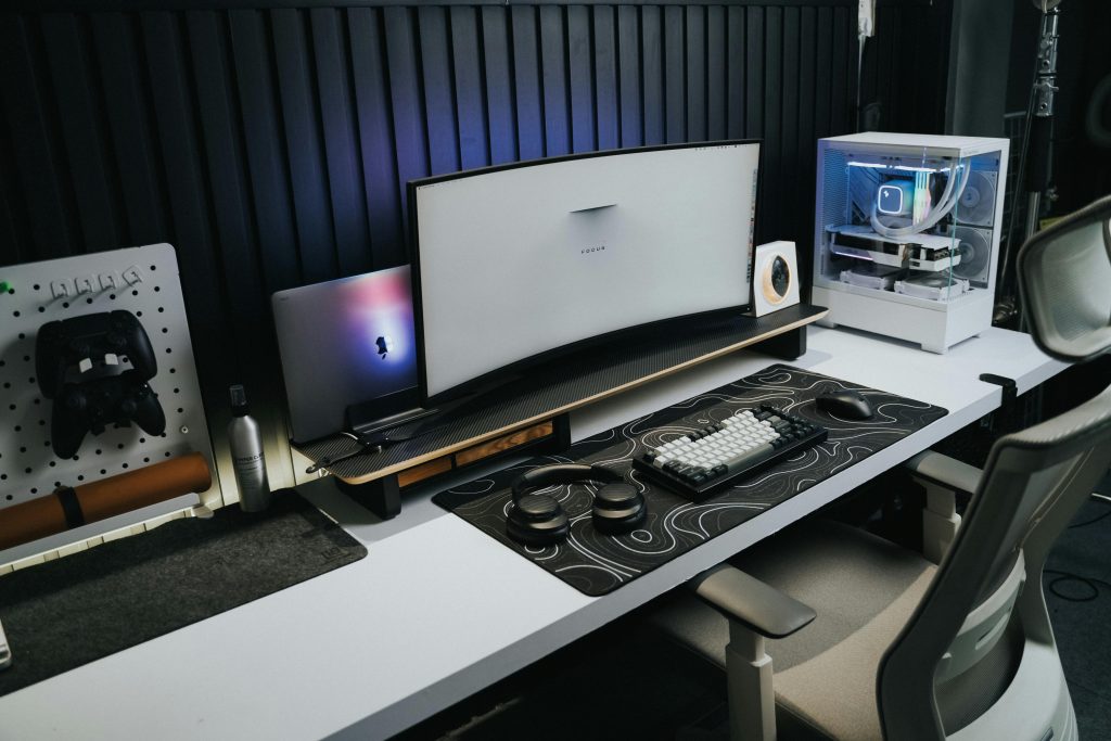 A computer desk with a monitor and speakers